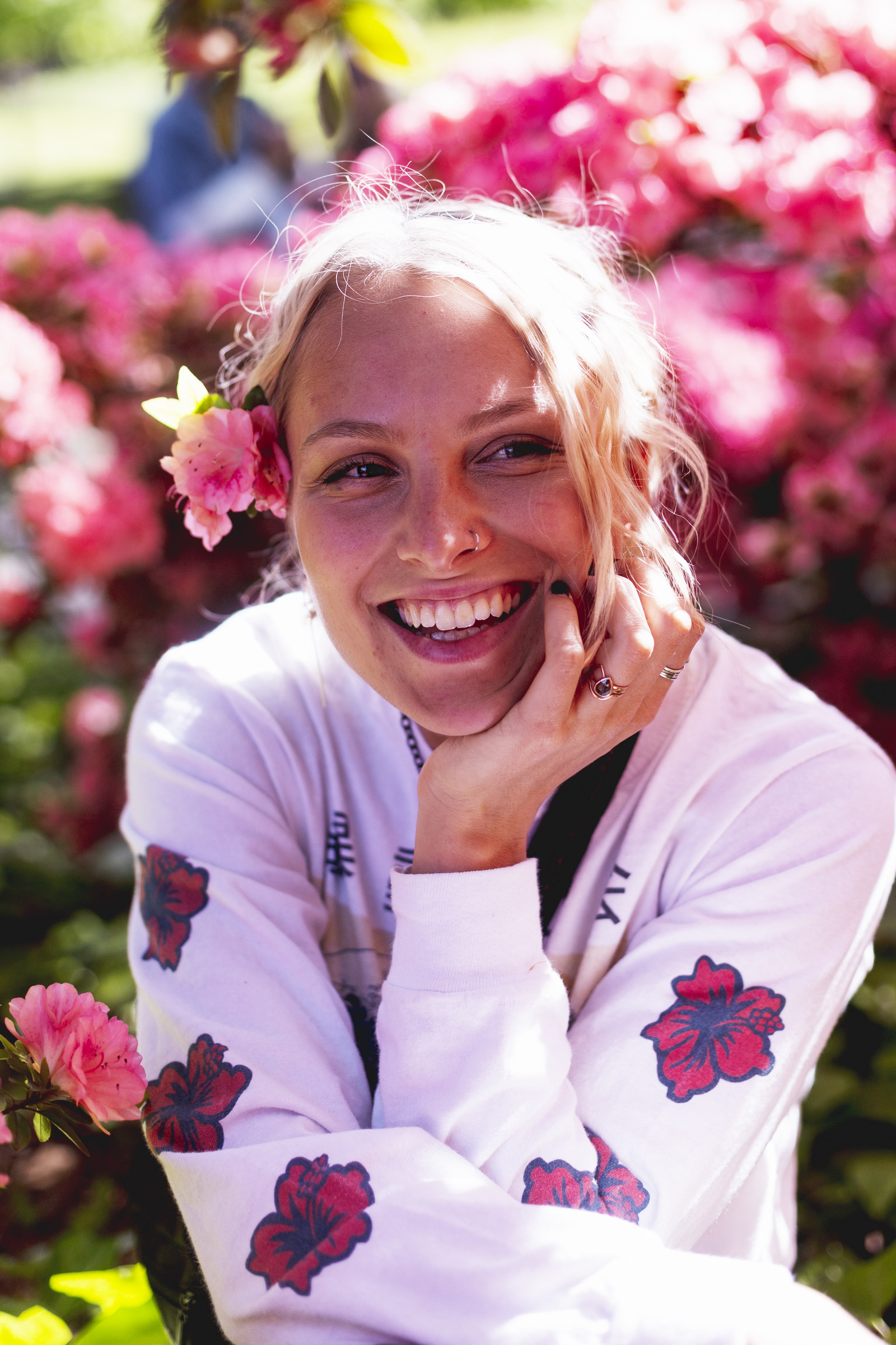 Emily Brimlow laughing in pink flowers